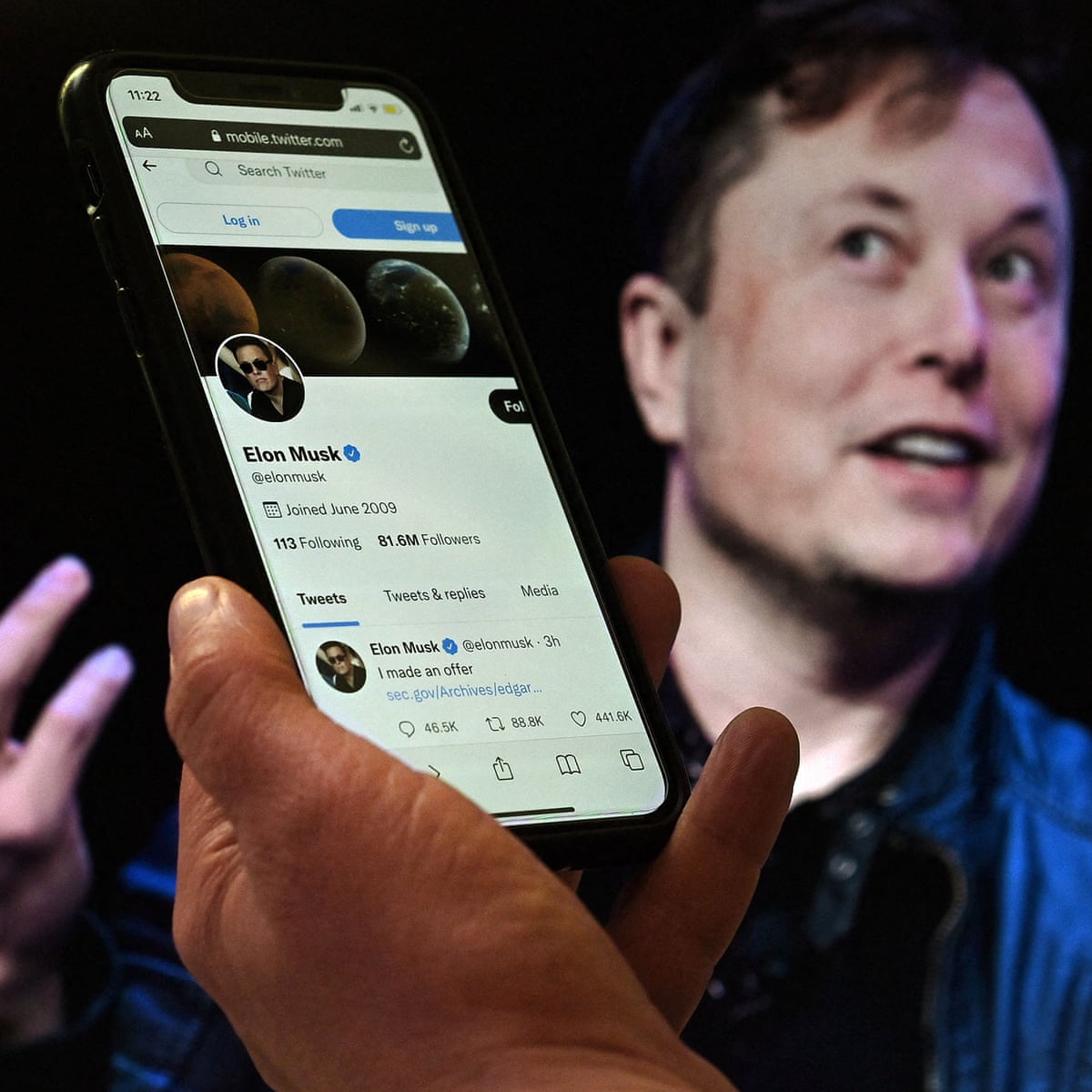 Elon Musk at podium tweeting on phone symbolizing high tweet volume prediction markets on Polymarket