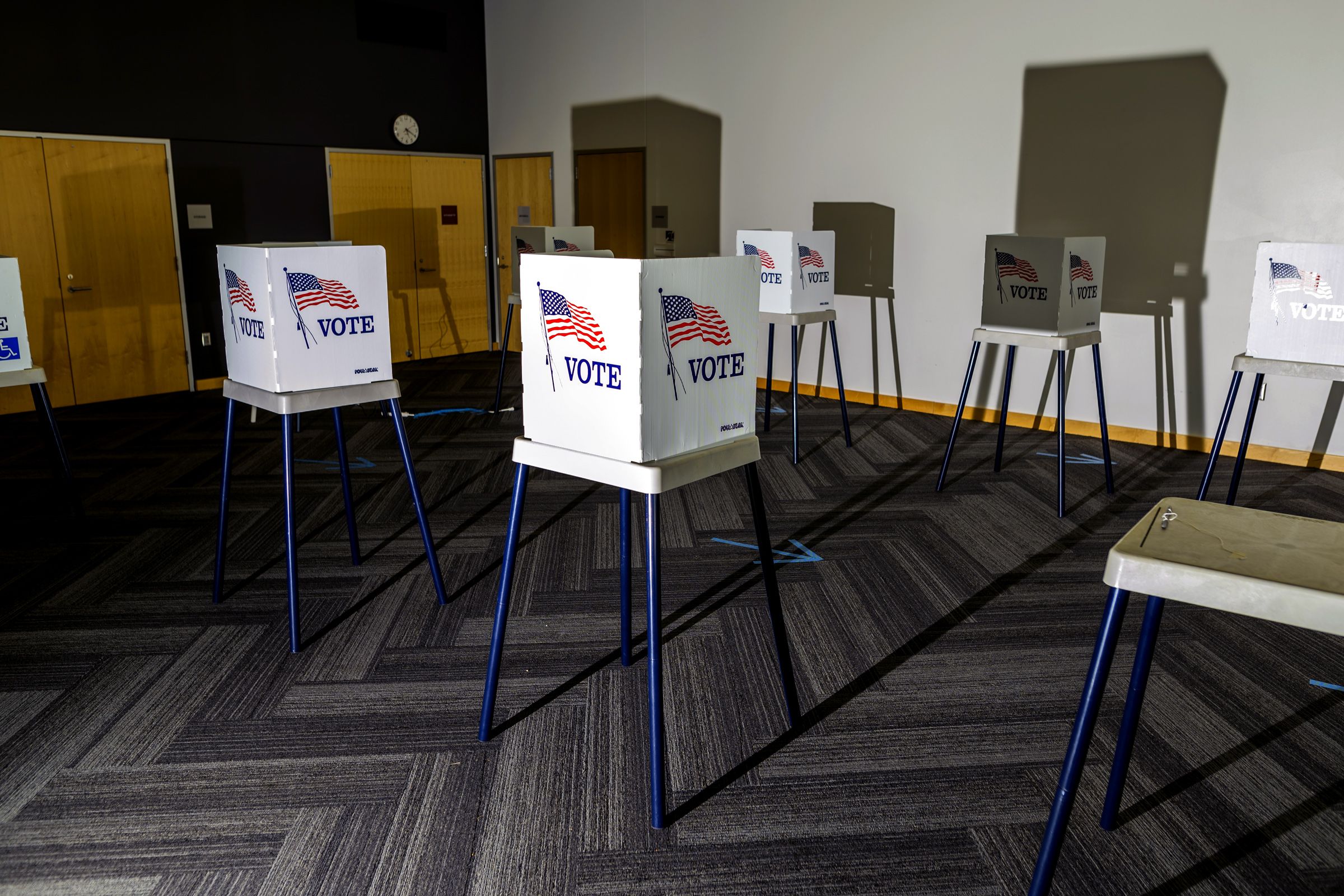 Modern polling station in Lima, Peru with voters using digital blockchain-enabled voting kiosks during election pilot
